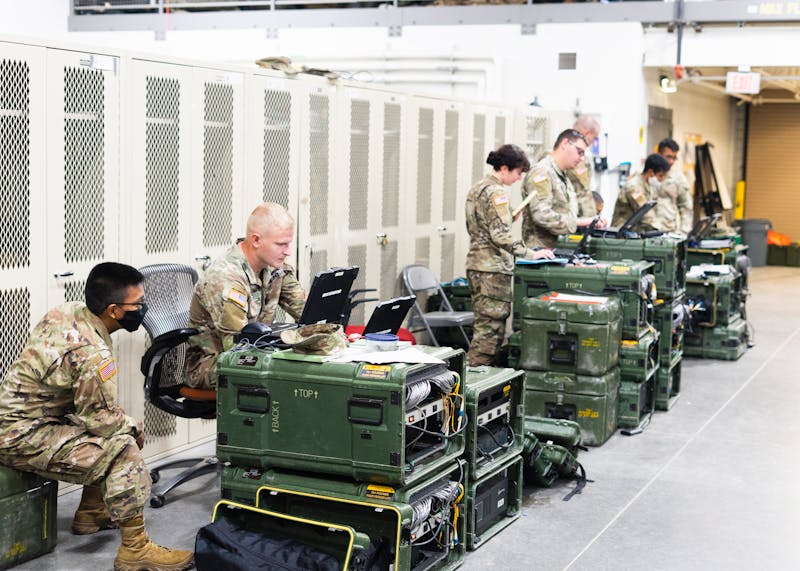 Military personnel with deployment gear and equipment